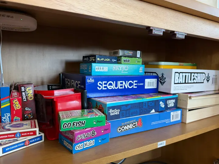 Board games and card games stocked in the second-floor living room
