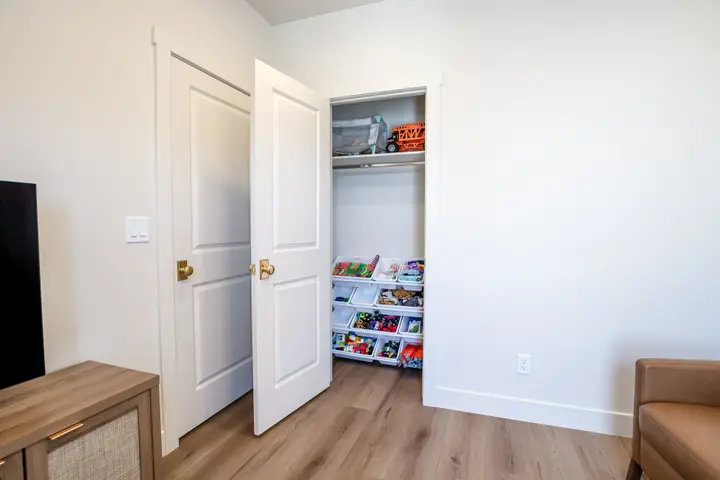 Third-floor game room with an organized children's toy closet