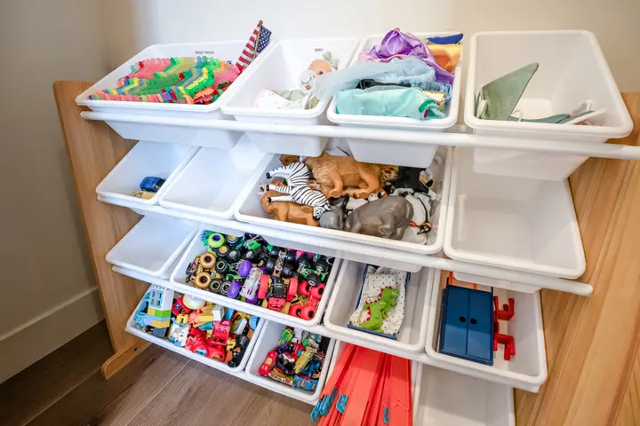 Organized children's toys and activity bins in the game room